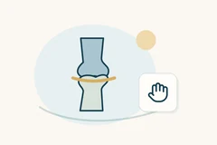Joint symbol crossed by a curved gold line beside a hand outline.