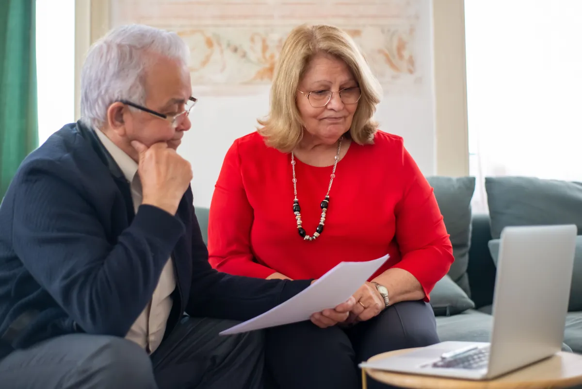 Older adults reviewing documents at home