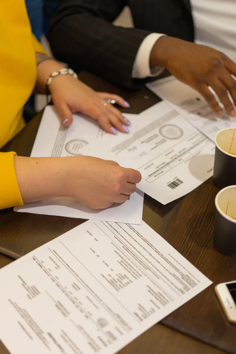 People reviewing paperwork together at a table